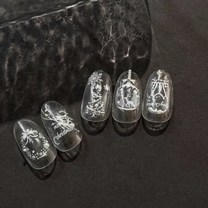 Christmas nail art press-ons with silver reindeer, white relief trees and pearl accents