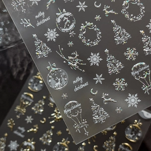 Laser silver Christmas nail stickers featuring snowflakes, reindeer and tree designs
