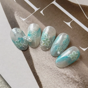 Blue and white gradient press-on nails with floral art and elegant pearl accents