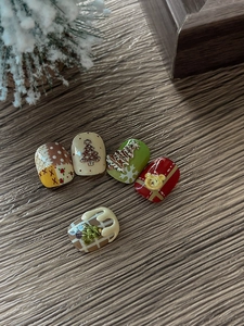 Macro detail of 3D Christmas nail art featuring embossed bears and festive patterns