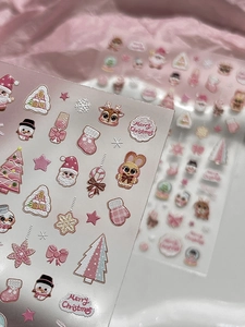 Detail of 3D embossed pink Christmas nail art stickers with Santa and reindeer motifs