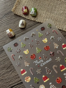 Detail of 3D embossed Christmas nail stickers featuring bear and tree designs
