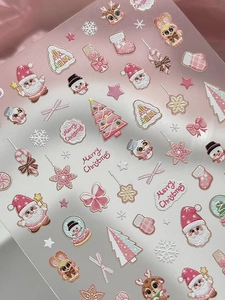 Detailed view of 3D pink Christmas nail stickers with embossed Santa and reindeer patterns