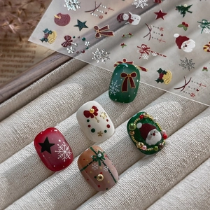 Festive silver foil Christmas nail art stickers with Santa and snowflake patterns