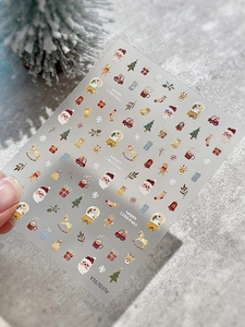 Detail of Christmas nail stickers featuring Santa Claus and reindeer designs