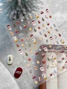 Detailed view of Christmas nail stickers with Santa, snowman, and reindeer patterns