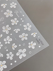 Detail showing 3D embossed white flowers with gold beads and stars nail art stickers
