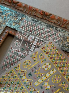 Detailed relief of Christmas grid nail stickers with gold foil bow and snowflake accents