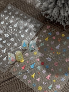 Detailed view of Christmas nail art stickers with 5D embossed trees and snowflakes