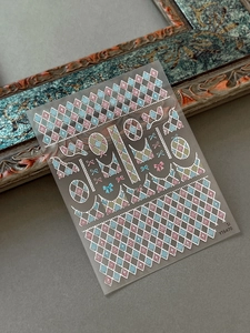 Detail of luxury gold foil Christmas nail stickers with argyle plaid and bow designs