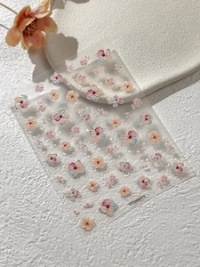 Detailed macro view of 5D embossed 3D nail stickers with colorful pastel floral patterns