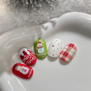 Christmas snowman press-on nails with red and green plaid patterns in a white heart dish