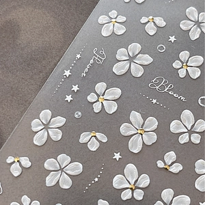 3D white floral embossed nail stickers with gold accents and elegant lettering
