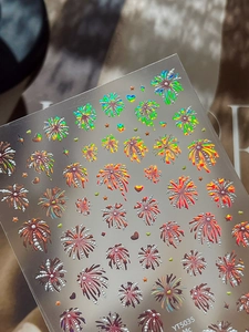 Macro detail of holographic firework and heart nail stickers in vibrant gradient colors