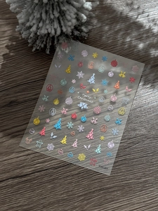 Detailed view of 3D embossed Christmas nail art stickers with Santa and reindeer motifs