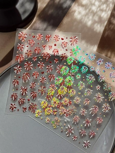 Detailed macro of festive firework nail art stickers with holographic glitter finish