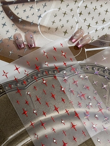 Detailed 3D nail art stickers featuring holographic star designs and glitter rhinestones