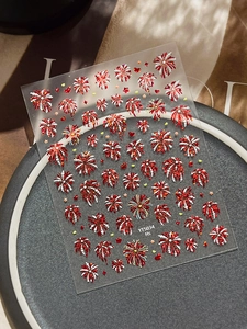 Detail of red fireworks nail stickers with sparkling glitter on transparent background