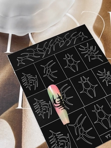 Macro detail of tribal totem nail art stickers with silver lines and gradient effect