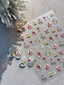 Detail of 3D embossed Christmas nail stickers featuring gingerbread houses and snowmen