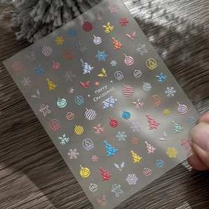 Embossed 5D Christmas nail art stickers featuring colorful reindeer and snowflake designs