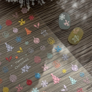 3D embossed Christmas nail stickers featuring snowflakes, trees, and colorful reindeer designs