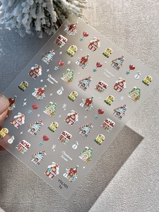 Detail of Christmas nail stickers with 3D embossed gingerbread house and snowman motifs