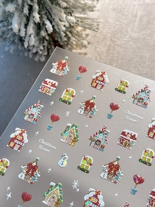 Detail of 3D embossed Christmas nail stickers featuring gingerbread house and snowman