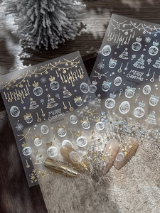 Close-up of gold and silver Christmas nail stickers with snowflake and star patterns