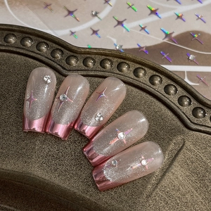Sparkling silver press-on nails with pink metallic French tips and star decals