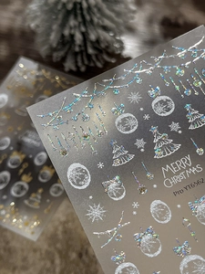 Macro shot of 3D Christmas snowflake nail stickers with holographic silver glitter effect
