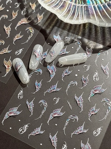 Detail view showing laser butterfly nail art stickers with iridescent holographic effects