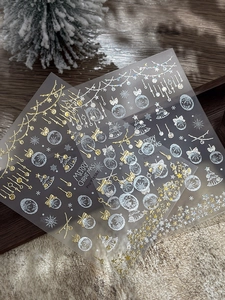 Detail of Christmas nail stickers with gold and silver laser snowflake and tree designs