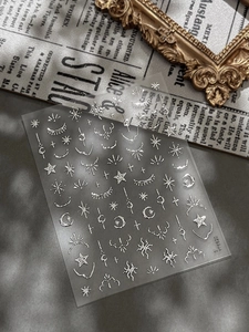 Silver vintage moon and star nail art stickers with celestial bohemian patterns on sheet