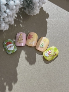 Macro shot of 3D embossed Christmas nail art with Santa Claus and snowflake motifs