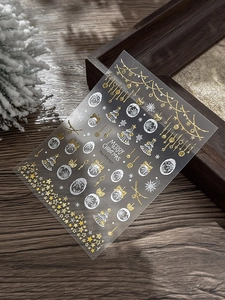 Detailed view of gold Christmas nail stickers with snowflakes and stars pattern