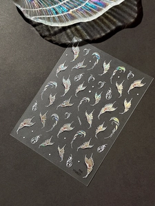 Detailed laser butterfly nail sticker with iridescent spiral patterns on a dark background