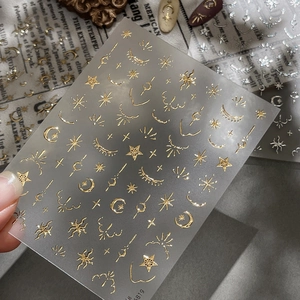 Golden hot stamping nail art stickers with moon and star patterns for elegant manicure
