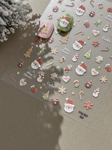 Detail of Christmas nail art stickers featuring Santa Claus and snowman motifs