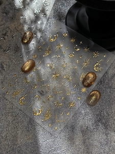 Detail view of gold and silver starry moon nail art stickers with butterfly patterns