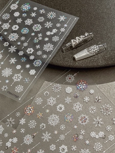 Detailed macro view of 3D embossed snowflake nail art stickers with laser laser effect