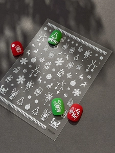 Detailed macro view of 3D embossed Christmas nail art stickers with snowflake and reindeer