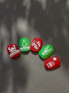 Detailed view of matte Christmas nail decals featuring embossed deer and tree designs