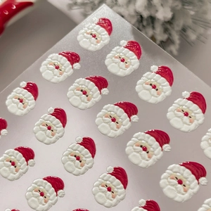 Autocollants 3D pour ongles Père Noël avec bonnet rouge sur feuille transparente