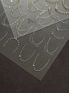 Detail of 3D metallic gold and silver bead chain nail stickers for French manicure