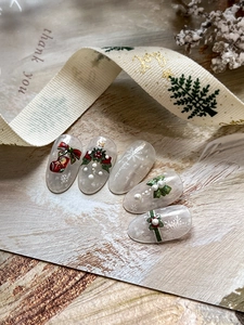Detail of Christmas nail art stickers with 3D embossed holly, wreath and sock designs