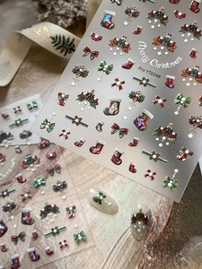 Macro detail of Christmas nail stickers YT6546 with 3D bows and festive wreath patterns