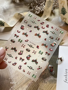Detailed 3D embossed Christmas nail art stickers with bows and holiday patterns