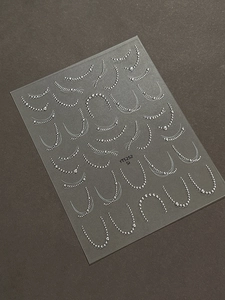 Detailed 3D embossed silver bead chain nail art stickers on a translucent sheet