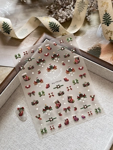 Detailed 5D embossed Christmas nail stickers featuring festive bows and holly leaves